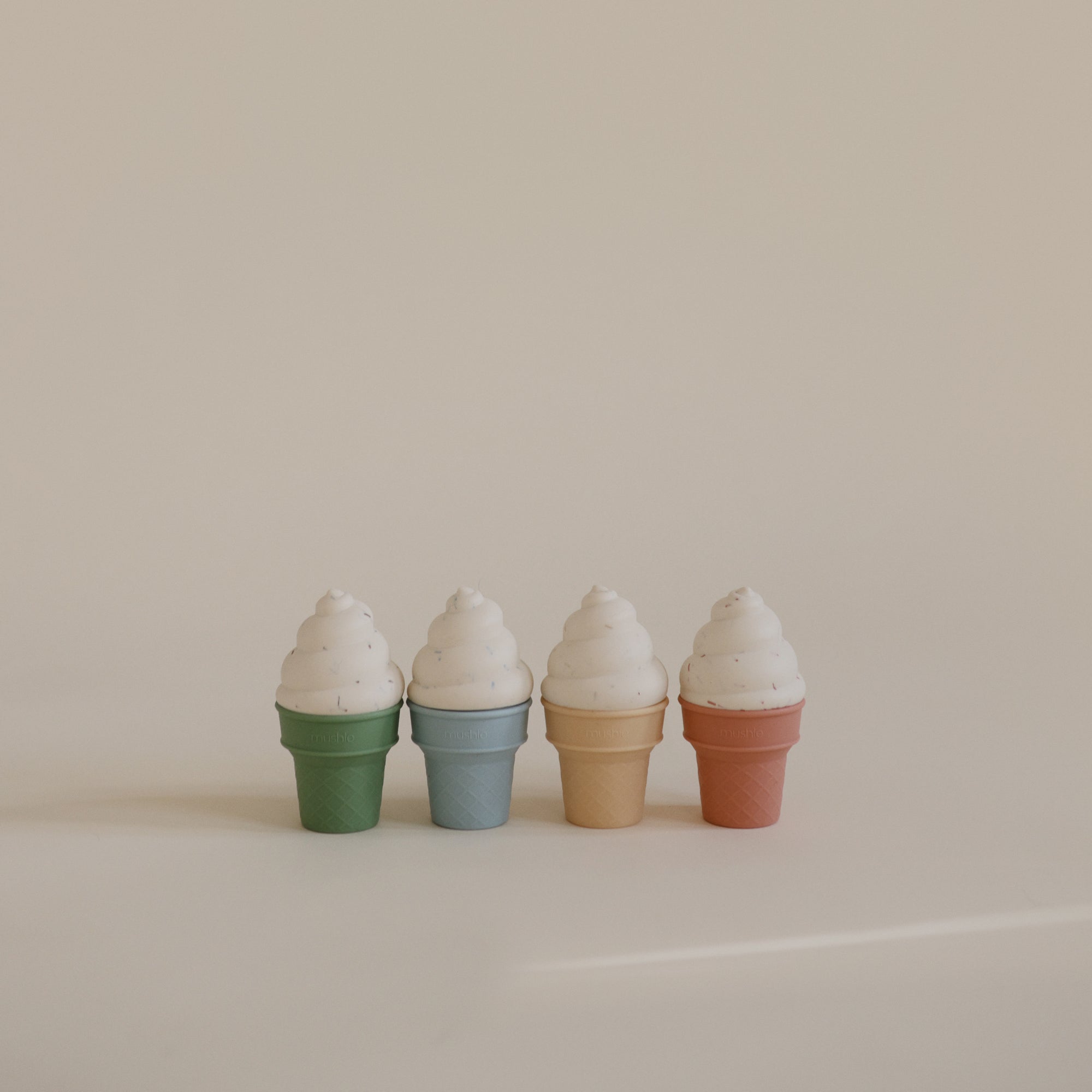 Mushie Mix and Match Toy: four pastel cones for color matching and fine motor skills.