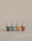 Mushie Mix and Match Toy: four pastel cones for color matching and fine motor skills.