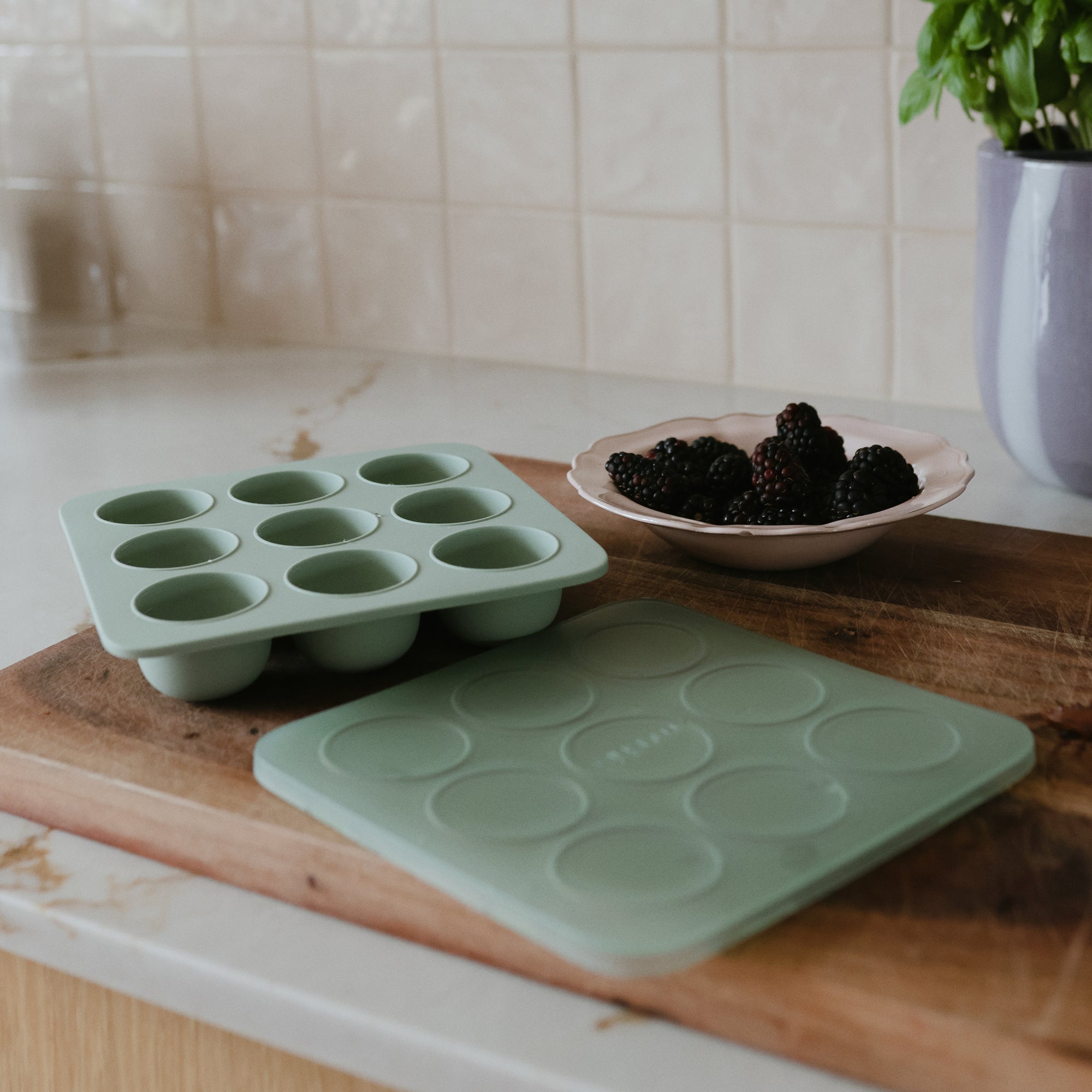Mushie Baby Food Freezer Tray: light green, BPA-free silicone with lid for storage and baking.