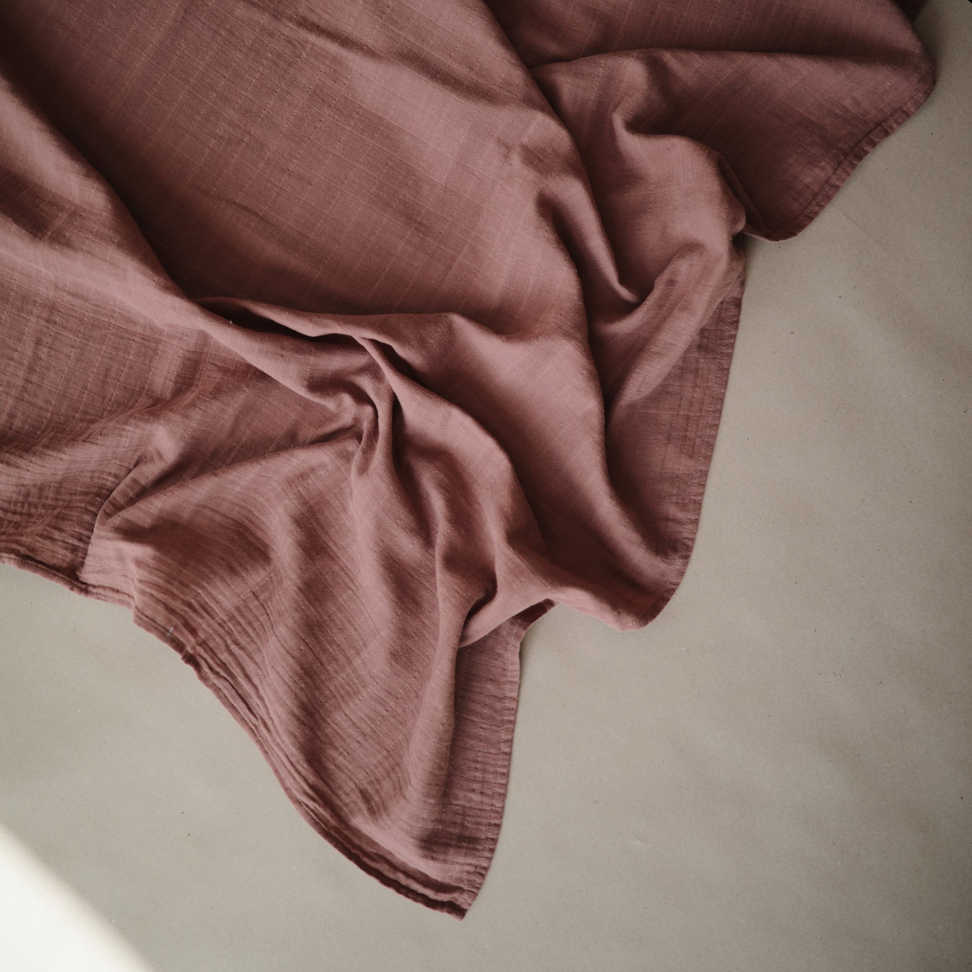 Lifestyle image of Organic Cotton Swaddle, Cedar