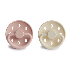 Front view of Blush and Cream Moon Silicone Frigg pacifiers. 