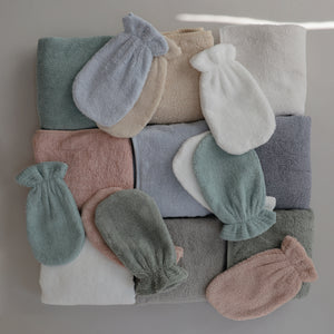 Lifestyle flatly of the Bath Mitt and Hooded Towel collection