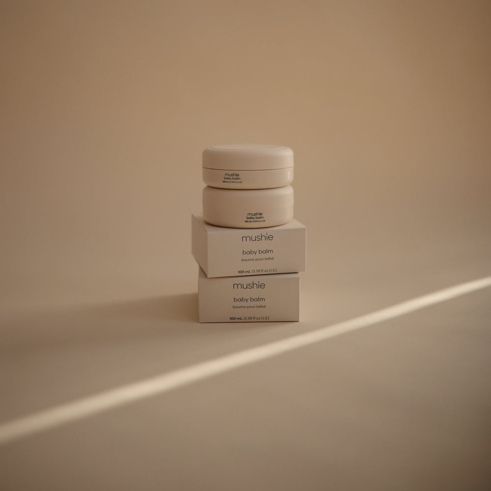 Lifestyle image of Baby Balm and packaging